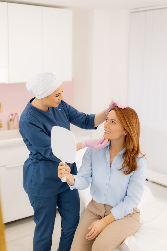 Client enjoying a skincare consultation while admiring her reflection in the mirror during a beauty treatment