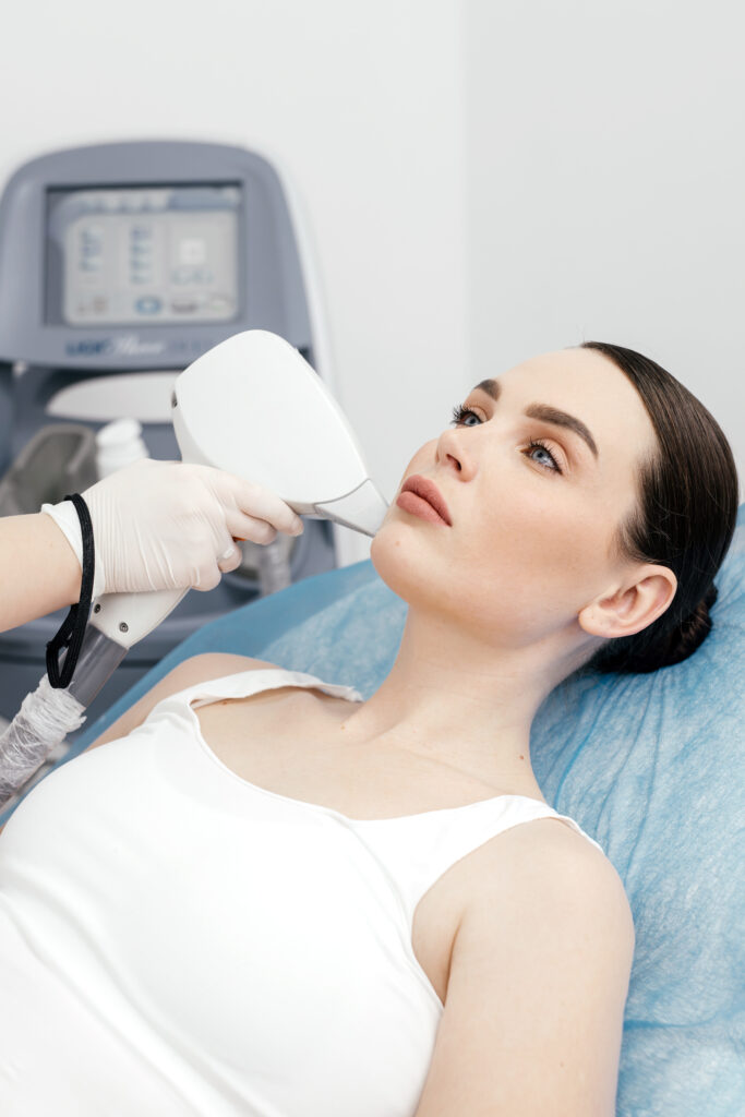 A woman enjoys a facial laser hair removal treatment in a beauty salon. Concept of advanced technology and professional skincare in a relaxing spa environment.
