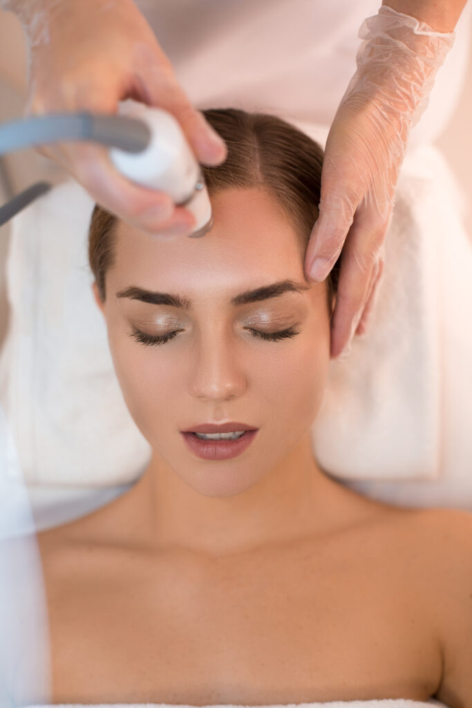 Cosmetologist undergoing skin treatment