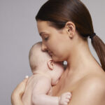 Mother holding her sleeping baby close to her chest